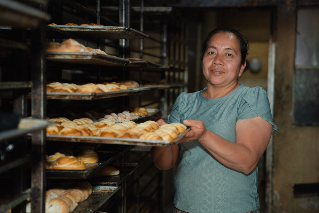 A Guatemalan woman works in a bakery.